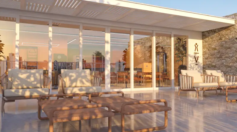 Rooftop com poltronas, pergolado e vista da cidade no fim da tarde